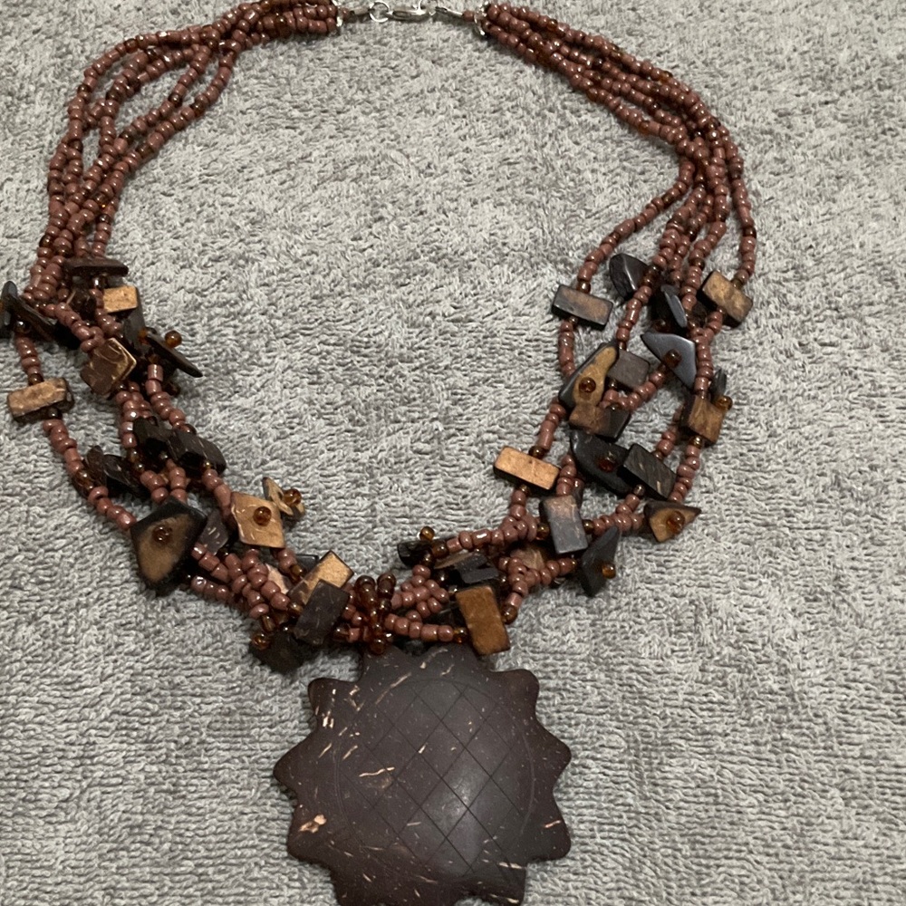 Multi-Strand Brown Beaded Necklace with Carved Pendant